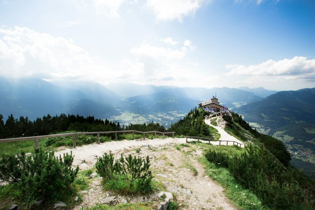 A scenic view of a mountain with a house on top
